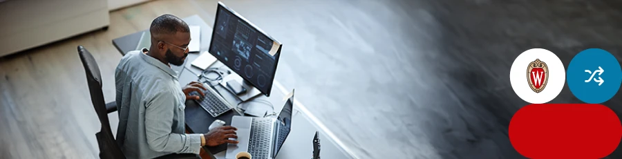 Writing on two keyboards - a lap top and a PC on a black table writing  a Conclusion about CompTIA CySA+ Certification