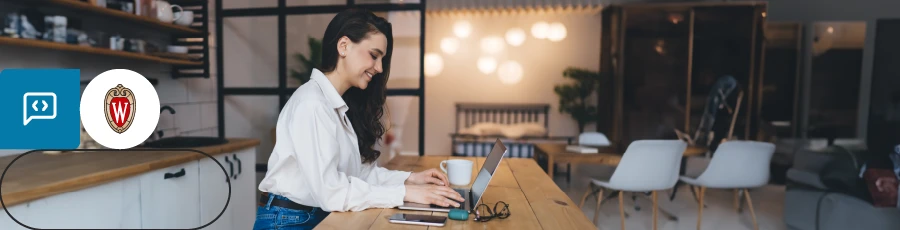 smiling while sitting and typing the computer is The Path to AWS Security Certification